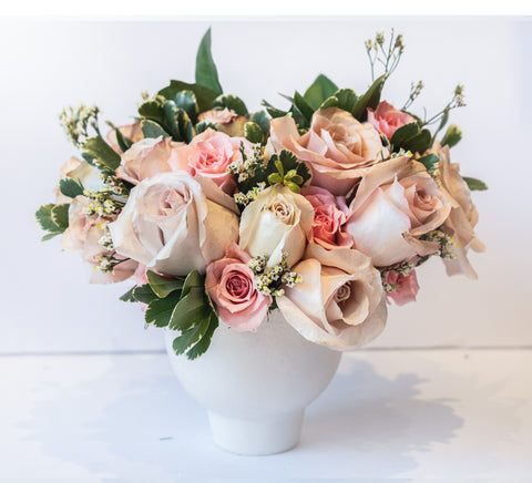 Pastel rose arrangement in a compote